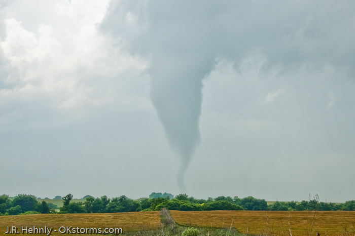 Tornado west of Bison, OK ramains on the ground for several minutes.