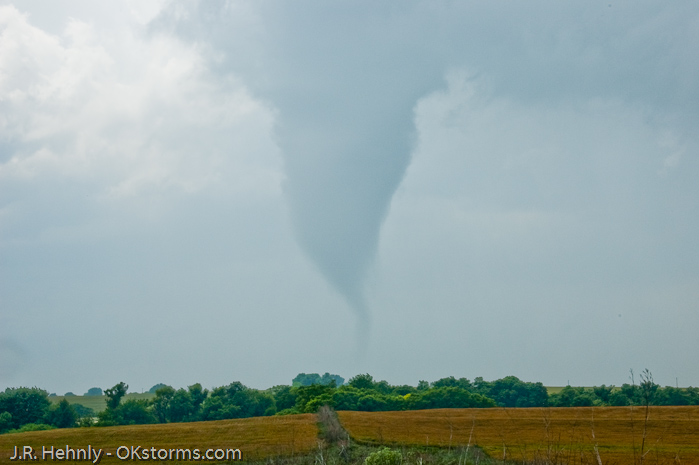 Tornado west of Bison, OK ramains on the ground for several minutes.